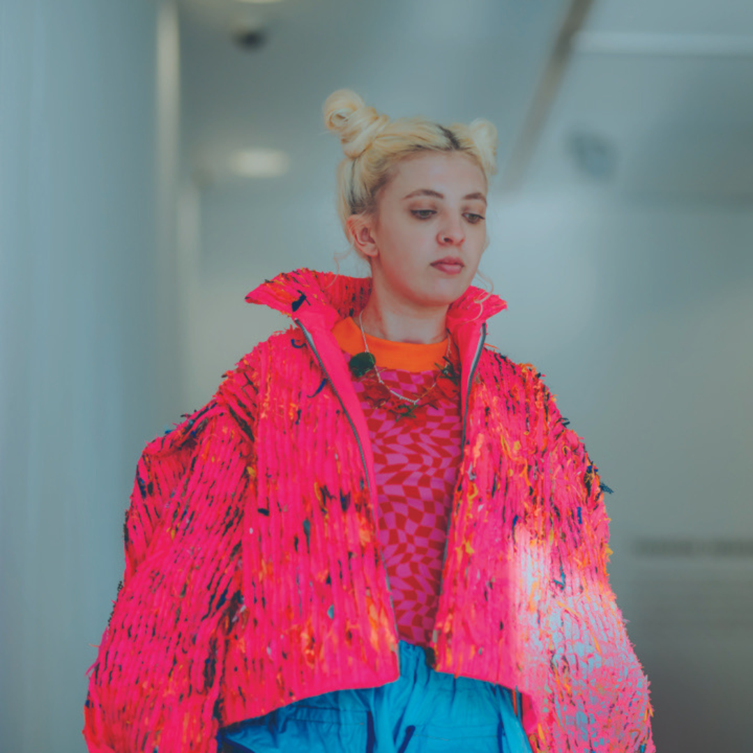 Katie Mc Millan BA Hons Fashion Design Woman wears pink over coat on fashion shoot catwalkpng